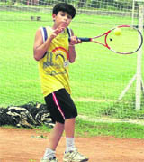 A participant in action during a match on the opening day of the AITA Total Tennis Talent Series at PAU campus courts in Ludhiana on Saturday.
