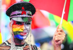 A reveller attends the Christopher Street Day (CSD) parade in the streets of Berlin on Saturday. Several thousand visitors took part at the 30th annual CSD parade in the German capital to demonstrate for the rights of all lesbian, gay, bisexual, transgender and transsexual people and to commemorate clashes between gay people and the US police in New York Citys Christopher Street in June 1969. 