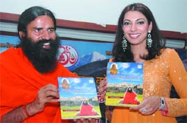 Yoga guru Swami Ramdev along with actress Yukta Mookhey releases a book titled 'Yog Darshan' at a press conference in New Delhi on Sunday