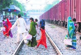 Unmindful of the danger it poses, passengers cross railway tracks at the Karnal railway station