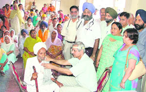 An ENT specialist examines patients at a medical camp organised by the IMA to mark Doctors Day in Ludhiana on Sunday. 