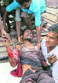 A bomb blast victim being taken to hospital in Guwahati on Sunday.