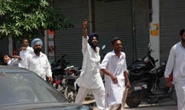 A SAD worker brandishes a revolver during the MC elections in Ferozepur on Monday. 