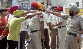 Independent candidates (top) arguing with cops during municipal committee elections in Goniana Mandi on Monday.