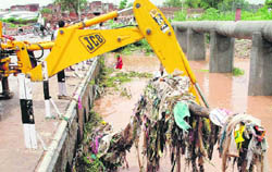 JCB clears the debris at Bapu Dham bridge.