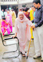 An old woman being escorted to cast her vote in Dera Bassi on Monday. 