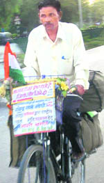 Ravinder Lakhe pedals his way to peace in Chandigarh on Monday. 
