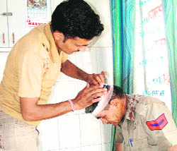 A policeman receives medical aid at a private hospital after being allegedly assaulted by irate residents of Sunarian Kalan village in Rohtak on Monday. 