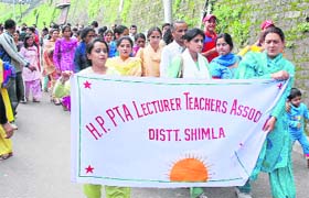 Members of the PTA Lecturers and Teachers Association take out a rally in support of their demands at The Mall in Shimla