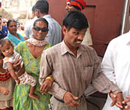A blind couple wait for their turn outside polling stations during the MC poll in Kapurthala on Monday.