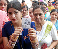 A newlywed woman shows her voter ID card.