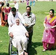 An elderly woman on a wheelchair on her way to a polling booth in Mandi Ahmedgarh.