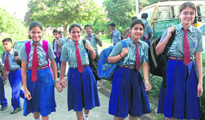 Students of KBDAV School, Sector 7, go to the school on the first day after summer vacations in Chandigarh on Tuesday.