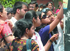 Students look at the second cut-off list at Hindu College in New Delhi on Tuesday.