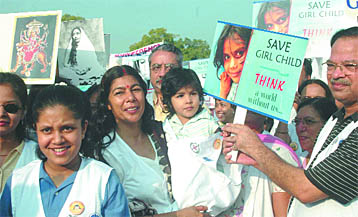 Doctors take out a silent march against female foeticide to celebrate the Girl Child Day at the India Gate in New Delhi on Tuesday.
