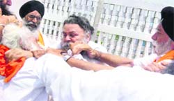 Akali leaders pull each others beard at the residence of the Jathedar of Sri Kesgarh Sahib in Anandpur Sahib on Tuesday.