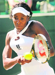US Venus Williams returns the ball to her Thai opponent Tamarine Tanasugarn during their quarterfinal match at the Wimbledon championships in London on Monday. 