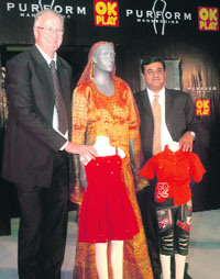 Managing director of Purform, Maurice Purdy and Rajan Handa, managing director, OK Play India Limited, pose with a mannequin in New Delhi on Wednesday.