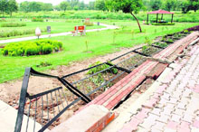 A portion of the railing on the wall at the entry to the green belt in Sector 29-C that caved in due to the recent rains in Chandigarh.