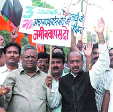 BJP leader Vijay Goel with party activists protests against the cancellation of land to Amarnath Shrine Board at Chandni Chowk in New Delhi on Wednesday.