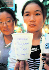 Tibetans take out a candlelight procession in Shimla on Wednesday.