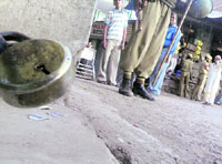 A CRPF personnel stands on guard during a strike in Rajouri town.