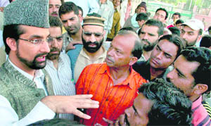  Chairman of the All-Party Hurriyat Conference Mirwaiz Umar Farooq interacts with Amarnath pilgrims and other tourists in Srinagar on Thursday