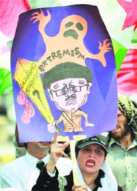 A Pakistani lawyer holds a placard as she chants slogans during a lawyers' strike in Lahore