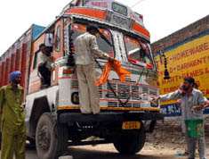 Truck drivers clean up their vehicle before starting their journey from Bathinda on Friday after their agitation was called off on Friday following agreement. 