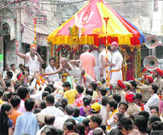 Devotees pay obeisence to Lord Jagannath as the Rath Yatra passes through the streets in Ludhiana on Friday.