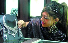 A visitor admires a jewellery set at the Business to Business Jewellery Exhibition, 'JCK New Delhi 2008' which was inaugurated at Pragati Maidan in New Delhi