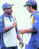 Sri Lankas Sanath Jayasuriya (L) gestures while talking with Kumar Sangakkara during training session at National stadium in Karachi on Saturday.