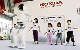 Asimo, an advanced humanoid robot made by Honda Motor Co, with children in Jakarta on Sunday. Asimo is in the country as part of its world tour to showcase its capabilities. 