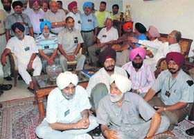 Members of the Indian Ex-servicemens League, Punjab and Chandigarh, wait to give a memorandum to union minister of state for finance Pawan Kumar Bansal at his residence in Chandigarh