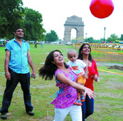 A family enjoys on the India Gate lawn in New Delhi on Sunday.