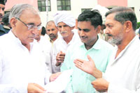 Chief Minister Bhupinder Singh Hooda listens to the grievances of people in Rohtak on Sunday.