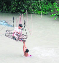 Chidren have fun while crossing the Beas in a jhoola at Nagwain, blissfully unaware of the risk to their lives. Such jhoolas are the only means to cross the Beas at several places.