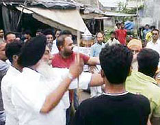 SAD leader Shivinder Singh Bajwa carrying a stick during a dharna held by residents in front of councillors house in Ludhiana on Sunday.