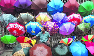 A vendor sells colourful umbrellas at Esplanade in Kolkata on a rainy Sunday. 