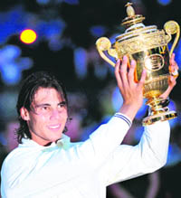 Rafael Nadal with the winners trophy after beating Roger Federer of Switzerland in the Mens Singles Final during the 2008 Wimbledon Championships at the All England Tennis Club in south-west London, on Sunday. Nadal won 6-4, 6-4, 6-7, 6-7, 9-7. 