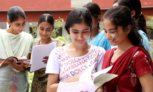A group of students at the SSD Girls College having a look at the prospectus and forms on Monday.