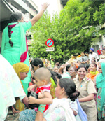Policemen lift anganwadi workers after they were arrested from the office of director, social security, women and child development, Punjab, in Sector 34, Chandigarh