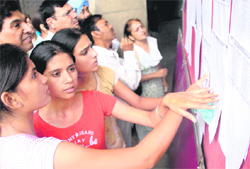 Students search their names in merit list of a college in Chandigarh