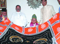 Former Prime Minister Atal Bihari Vajpayee holds a chaddar to be sent to the Dargah of Ajmer Sharif of Khwaja Moinuddin Chishti, at his residence in New Delhi on Monday.