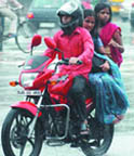 Tribune photographer Manas Ranjan Bhui catches the reactions of bird and man on his camera as rains lash the Capital in the evening on Monday. While this peacock at the residence of former Prime Minister Atal Bihari Vajpayee welcomes the showers by spreading its glorious wings, the motocyclist on the right and his two pillion riders dont seem too happy as they are drenched after being caught unawares in the downpour.