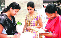 Students fill admission forms on the Maharshi Dayanand University campus in Rohtak.