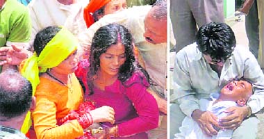 Roop Singhs wife, Nira, is consoled by relatives in Dhaban village on Tuesday; and (right) son Lalit Kumar wails in the lap of his maternal uncle