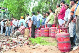 Long queues of consumers seeking refill of LPG cylinders during the four-hour curfew relaxation in Jammu on Tuesday.  PTI