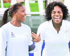 Serena Williams (right) and Mashona Washington of the Washington Kastles laugh during warmups before a World Team Tennis match against the Boston Lobsters on Tuesday in Washington.