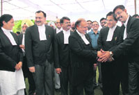 Chief Justice Vijender Jain shakes hands with newly-appointed judges after the oath ceremony in Chandigarh on Thursday.